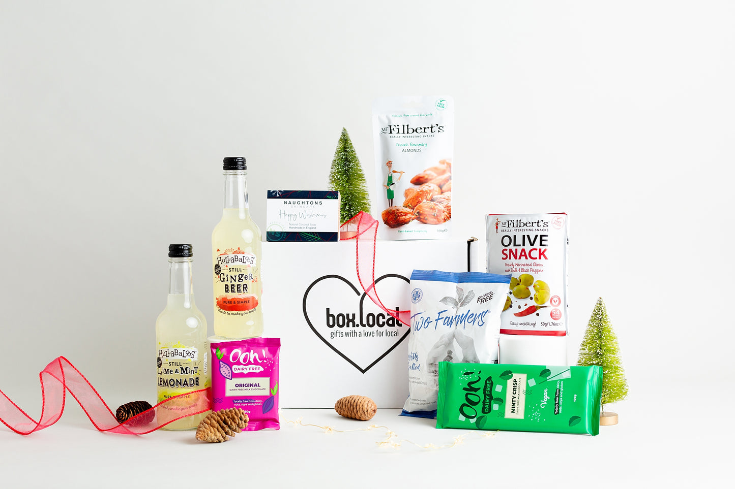 This fantastic Christmas Hamper includes:
Hullabaloos Still Ginger Beer 330ml
Hullabaloos Still Lime and Mint Lemonade 330ml
Ooh! Chocolata Dairy Free Minty Crisp Chocolate Bar 100g
Ooh! Chocolata Dairy Free milk Chocolate 50g
Naughtons Skincare Happy Washmas Soap
Mr FIlbert's French Rosemary Almonds 100g
Mr Filbert's Olive Snack Pack Marinated Olives with Chilli and Black Pepper 50g
Two Farmers Individual bag Lightly Salted Crisps 40g