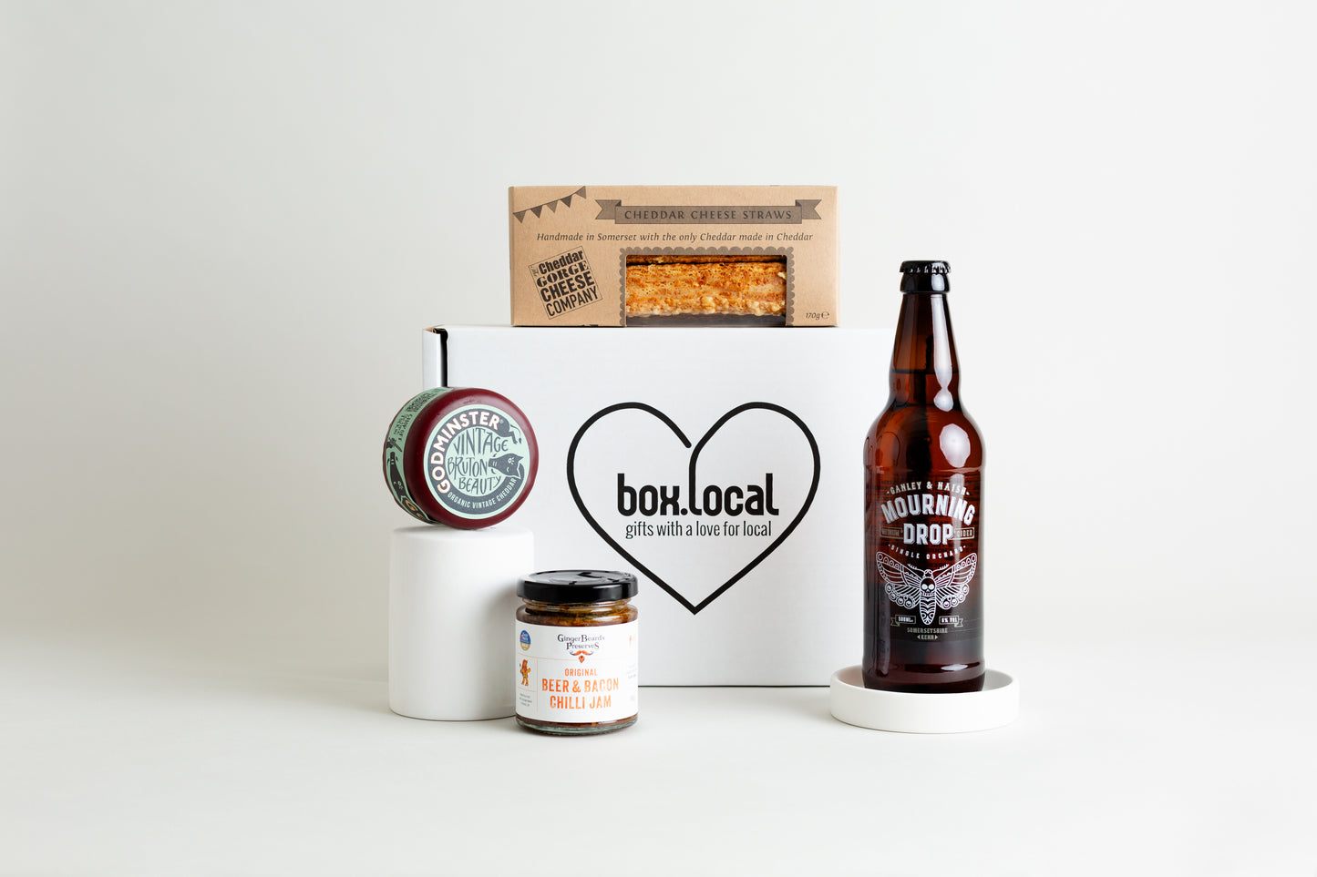 This fabulous hamper includes:

The Cheddar Gorge Cheese Co. 5 Cheese Straws 170g

Godminster Vintage Organic Cheddar Truckle 200g

Ganley and Naish Mourning Drop Cider 500ml

GingerBeard's Preserves Beer, Bacon and Chilli Jam 200g