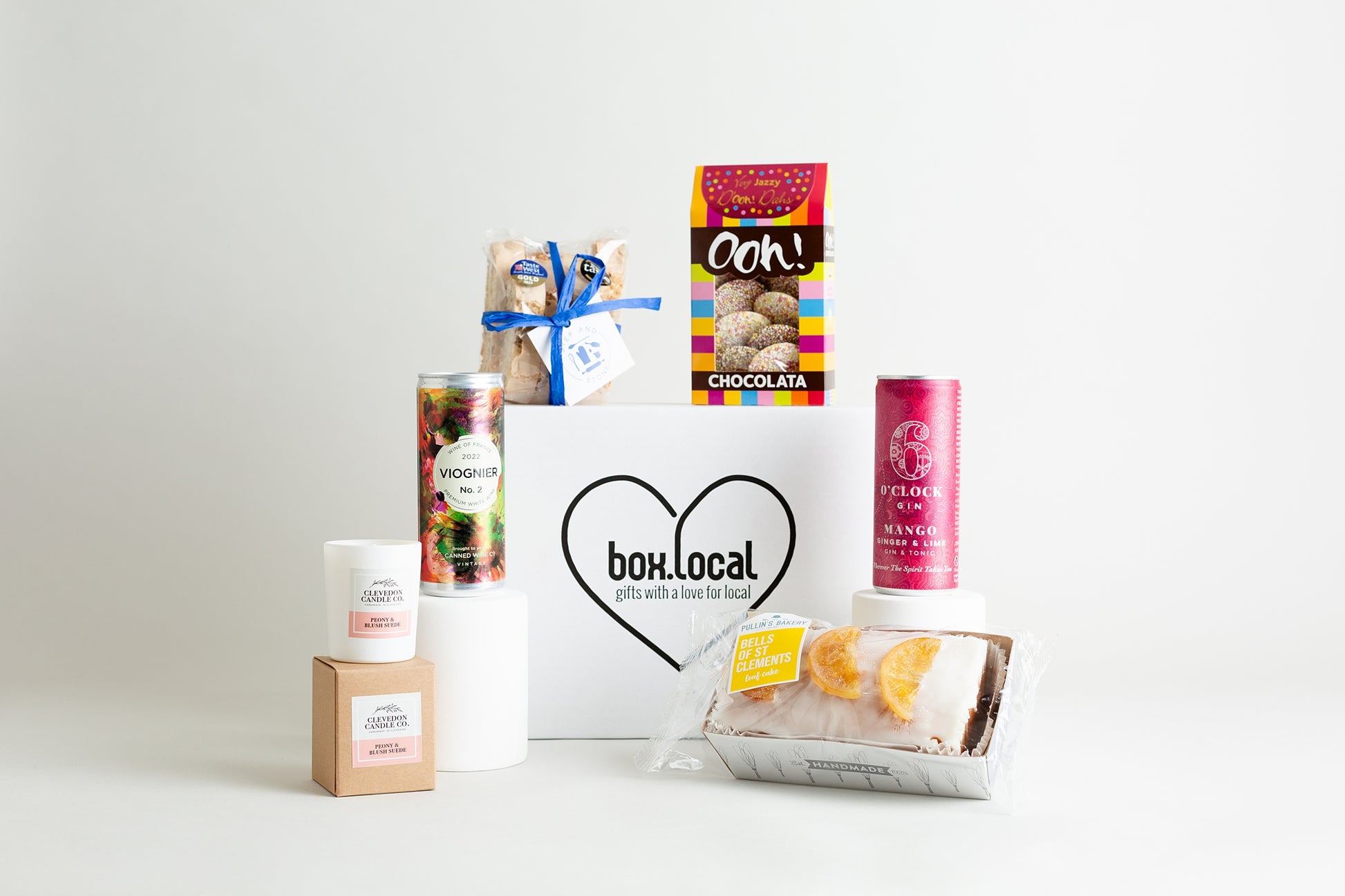 This fabulous hamper includes:

Ooh! Chocolata Very Jazzy D'ooh! Dahs 100g

6 O'clock Gin Mango Ginger &amp; Lime 250ml

Pullin's Bakery Bells of St Clements Loaf Cake 360g

Clevedon Candle Co. Peony and Blush Suede Candle

Canned Wine Co. 2022 Viognier 250ml

Step and Stone Hazelnut, Cardamom and orange Biscotti 125g